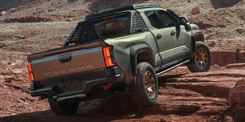 2025 Toyota Tacoma TRD Pro climbing rocky terrain, rear view

