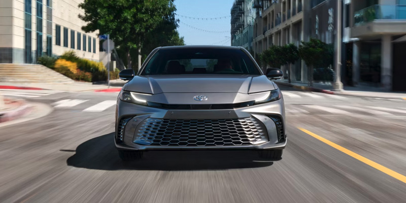 2025 Toyota Vehicle front view driving in city street

