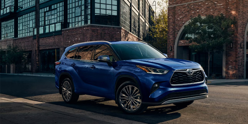 Blue Toyota SUV parked city street
